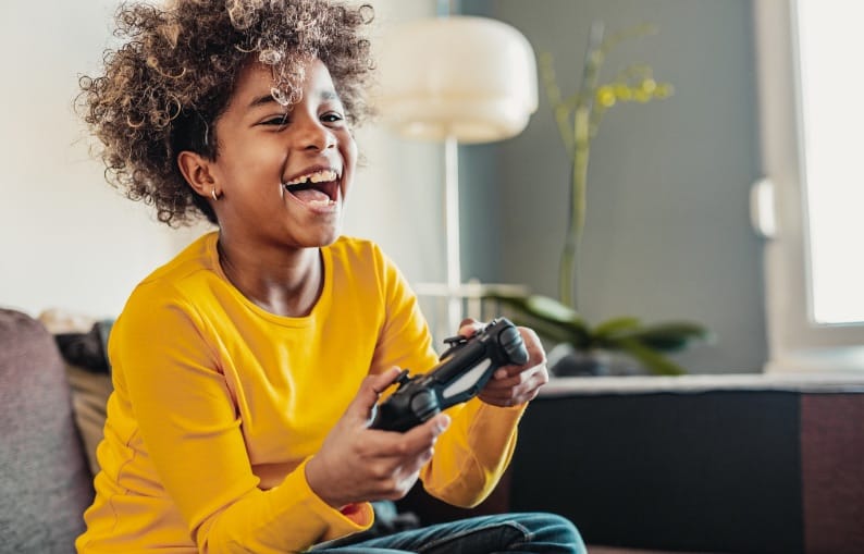 Kid playing on the PlayStation header banner